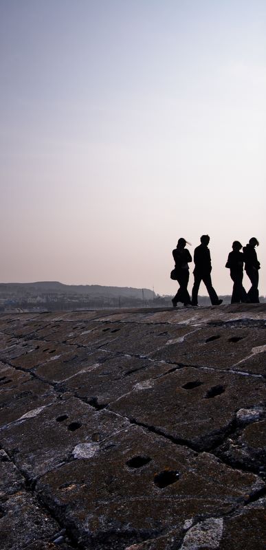 Afternoon Walk in Howth: Silhouettes of walkers at Howth, North Dublin Coast, Ireland.